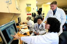 Dr. Vladimir Kvetan (standing) with Dr. Graciela Soto and Dr. Andrew Lee 